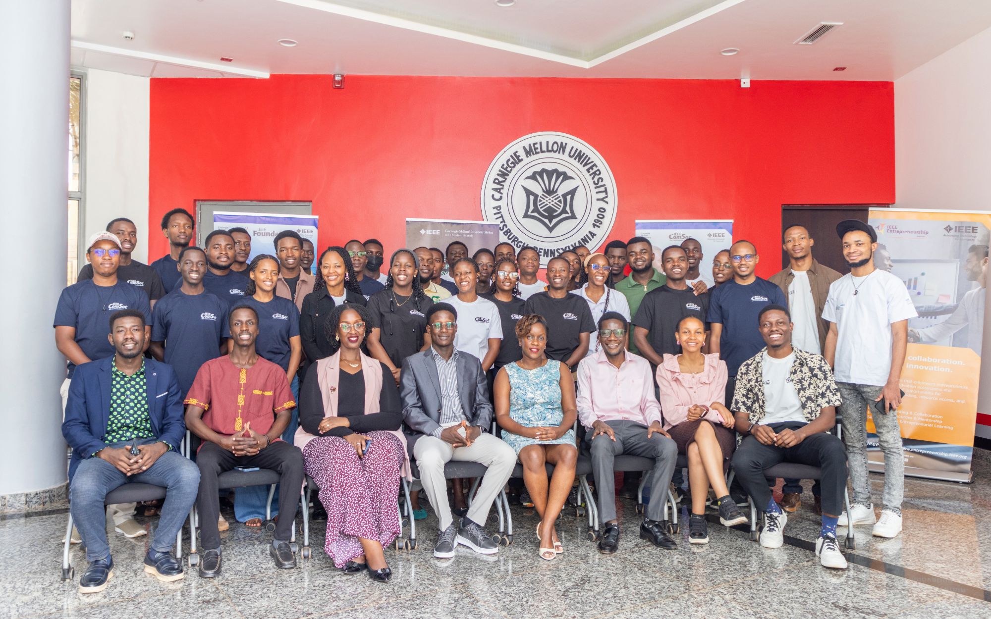 IEEE student branch members and guests in front of the Carnegie Mellon University seal