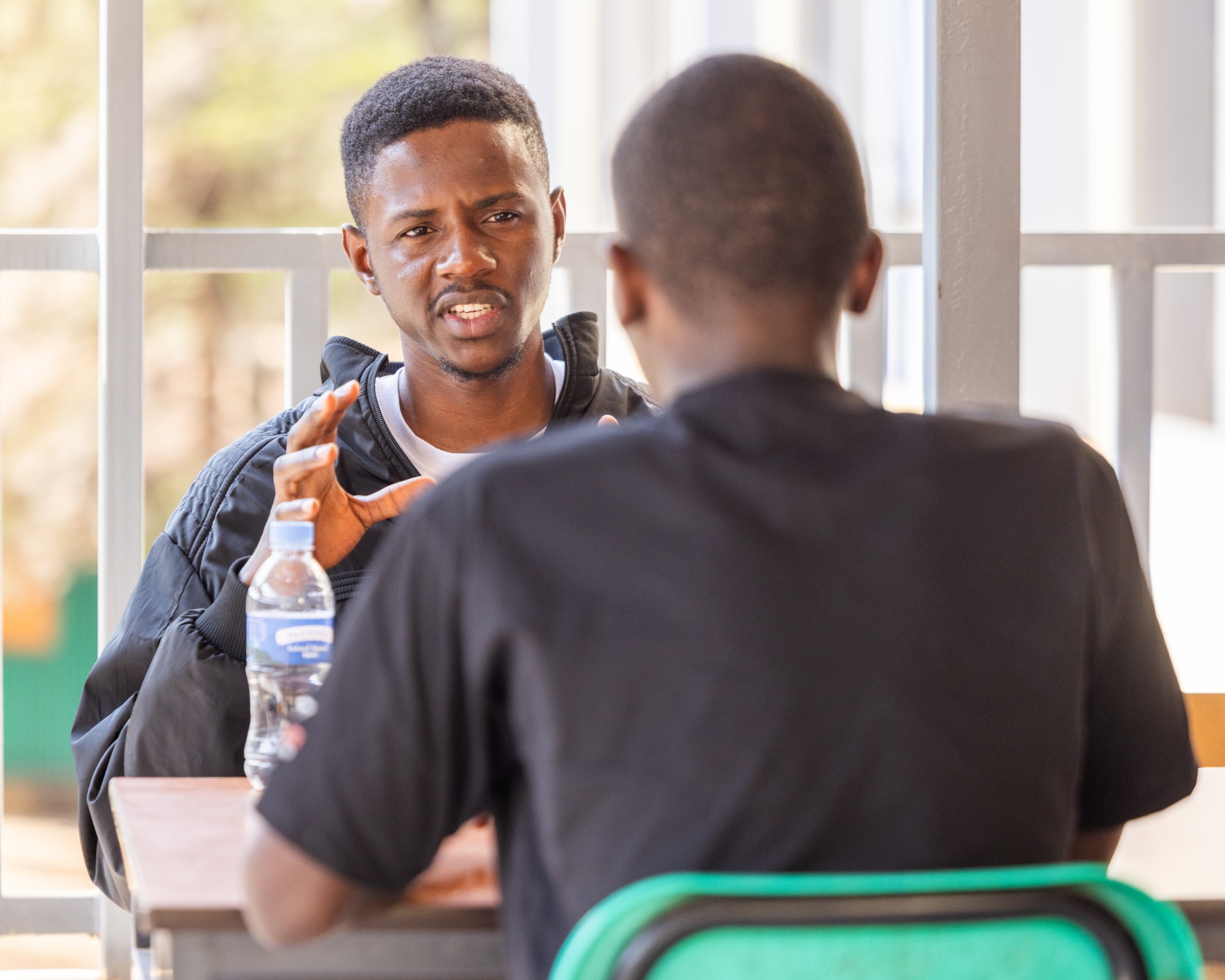 Two students in deep conversation during a mentoring session