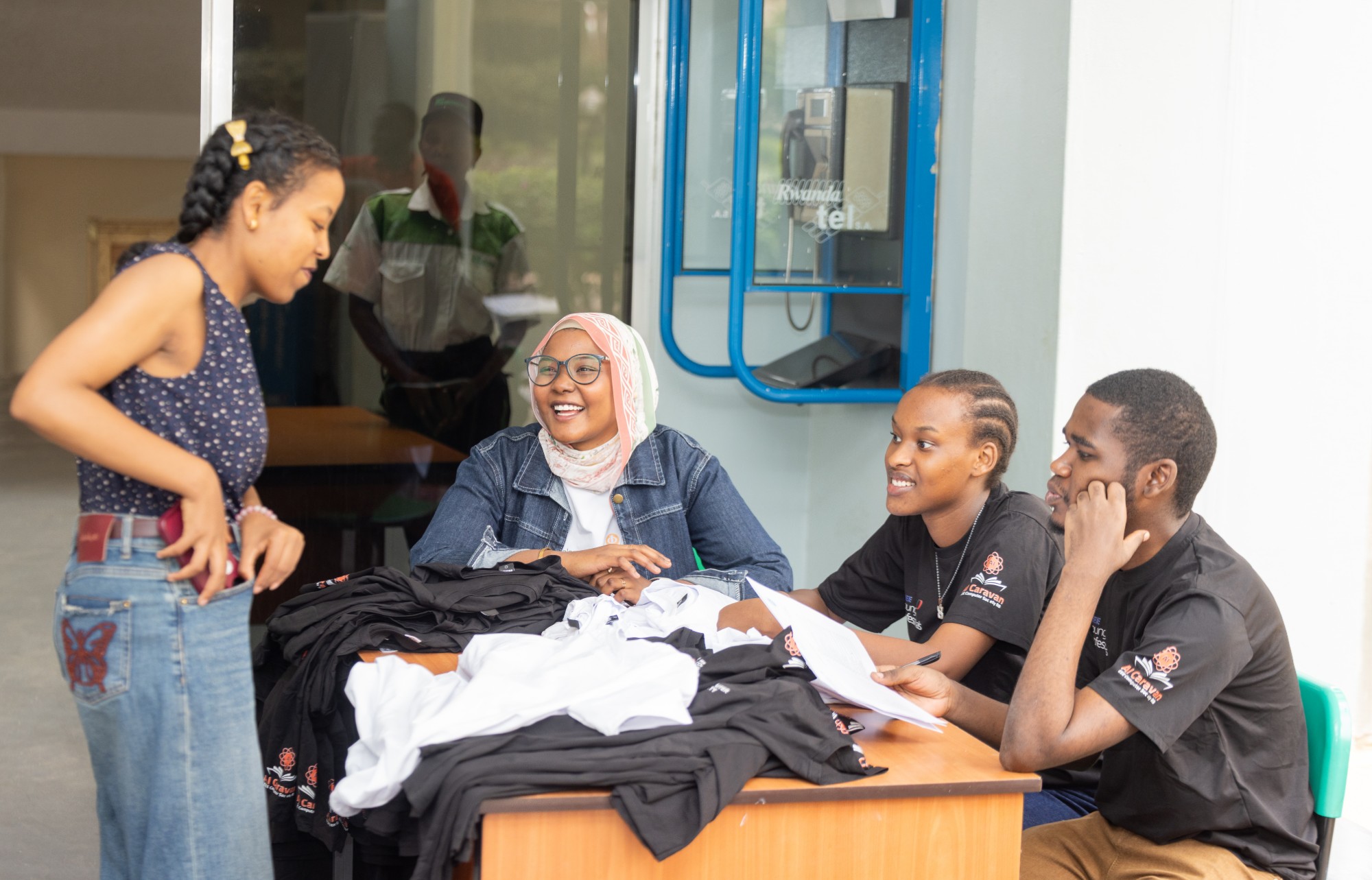 Volunteers at the registration desk with event T-shirts